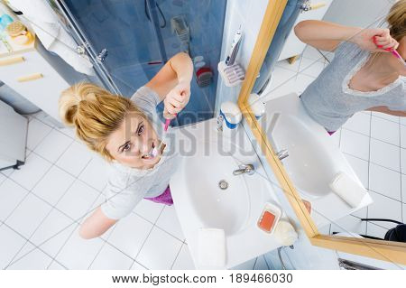 Woman Brushing Cleaning Teeth In Bathroom