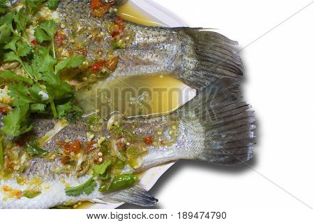 Steamed sea bass with lemon chili and garlic sauce in bowl on white color background. selective focus with clipping path.