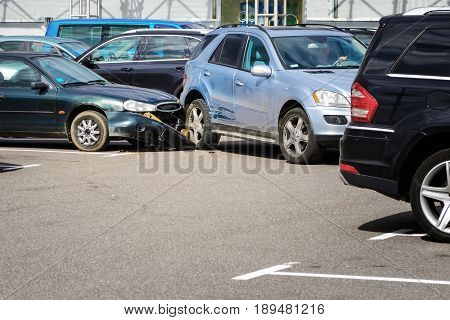 Car accident in the parking lot. Inattention behind the wheel concept
