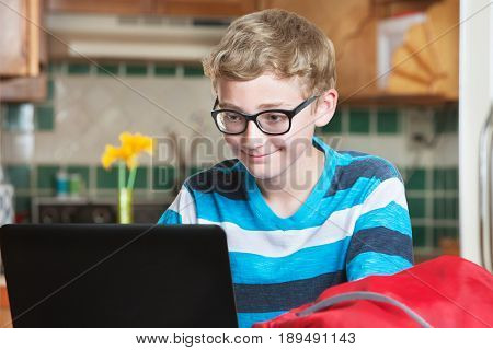 Grinning Child Using Laptop Computer
