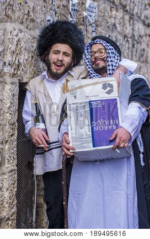 JERUSALEM - MARCH 13 : Ultra Orthodox men holding Mishloach Manot during Purim in Mea Shearim Jerusalem on March 13 2017 Mishloach Manot is traditional food gifts given during Purim