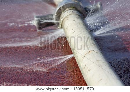 water leaking from hole in a hose