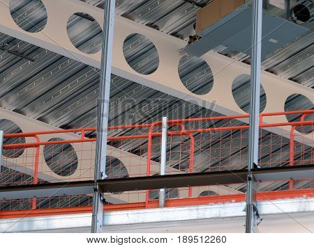 building development construction site with beams fencing girders and scaffold