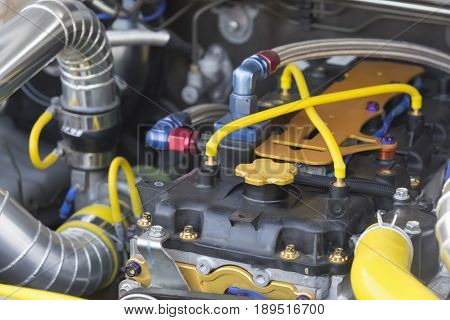 Tube on diesel racing car engine in garage