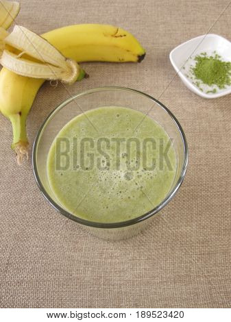 Drinking glass of matcha shake with banana