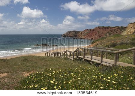 Wooden walkway leading down to Amado Beach Algarve Portugal