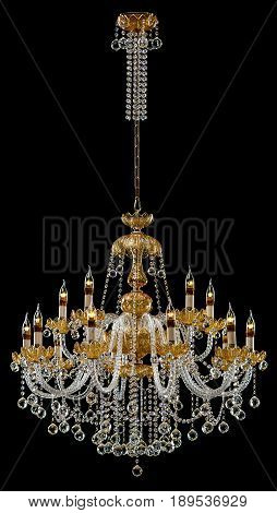 Large crystal chandelier with candles isolated on black background. Luxury royal expensive chandelier for living room, Hall of celebration.
