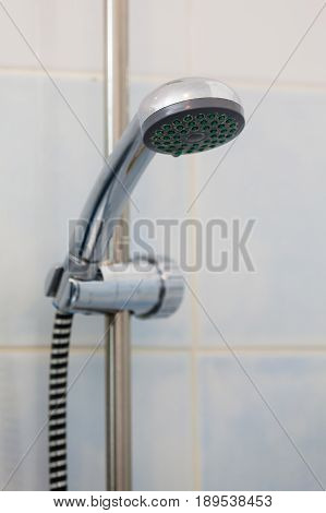 Bathroom sanitary objects details concept. Metal steel silver handshower under shower place