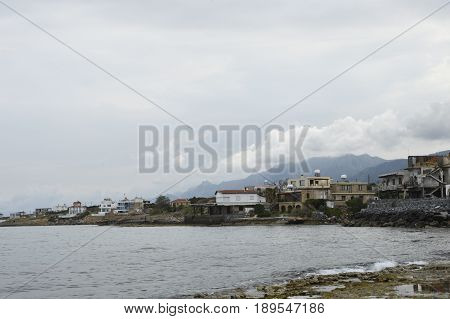 Coast down the little village Lapta with some house near the sea and the Kyrenia mountains in background picture from the North of Cyprus.