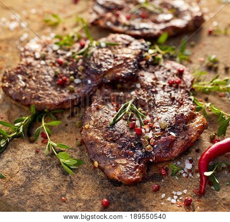 Grilled pork neck steak sprinkled with herbs and spices
