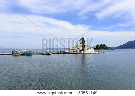 KANONI, GREECE - MAY 15: Tourists visit the old Greek Christian Orthodox church Vlacherna Monastery on May 15, 2017 in Kanoni, Corfu island in Greece.