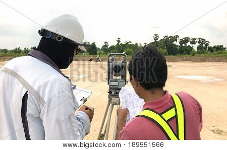 Construction engineer hodling construction drawing and smart tablet with foreman worker checking construction site for new Infrastructure construction project