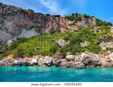Beautiful view on Blue caves and blue water of Ionian sea on Island Zakynthos in Greece and sightseeing points on the rock. Boat trip from Agios Nikolaos port. Best famous sightseeing tours boat trips