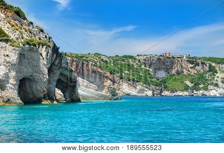Beautiful view on Blue Caves and blue water of Ionian sea on Island Zakynthos in Greece and sightseeing points and hotels on the rock. Boat trip on Greece holidays vacations tours travels trips