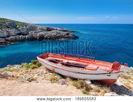 Old red and white very old boat and beautiful view on blue water of Ionian sea on Island Zakynthos in Greece. Sightseeing point for tourists. Greece holidays in Porto Limnionas Tavern. Greece islands