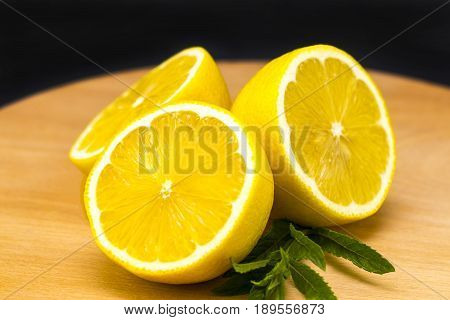 Half Of Lemon On A Wooden Board. Lemons  On A Wooden Background. Lemons. Fruits. Lemon Halves. Mint.