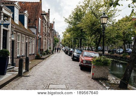 Monnickendam Netherlands - August 08 2016. Street view with old traditional houses and canal in the dutch village of Monnickendam. The town was founded by monks and it is a small fishing village today