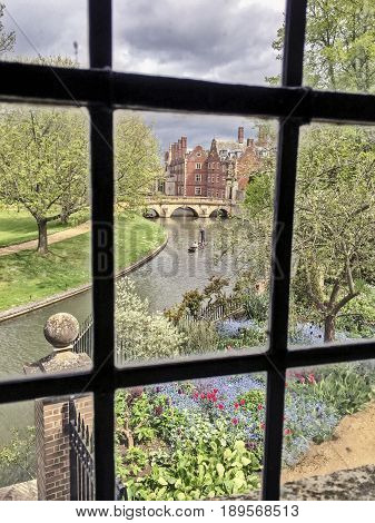 A view of the River Cam with a punt being poled along the river from the Wren Library in Trinity College. The library is part of Cambridge University.