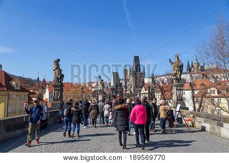 Prague, Czech Republic - March 16, 2017: People walking on the damous Charles Bridge in the city centre