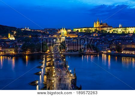 View of Charles Bridge, Prague Castle and Vltava river in Prague, Czech Republic during blue hour.