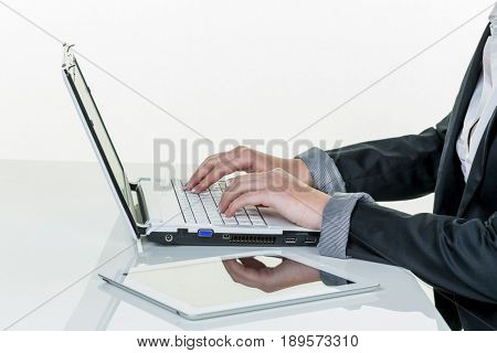 woman in office with laptop com puter