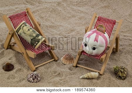 deckchair with piggy bank and dollars
