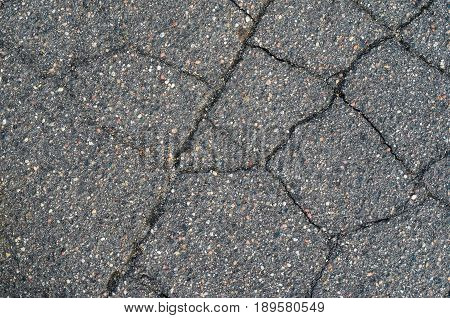 Asphalt texture with cracks. The texture of asphalt strongly cracked over time