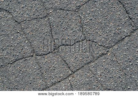 Asphalt texture with cracks. The texture of asphalt strongly cracked over time