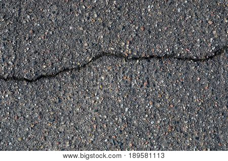 Asphalt texture with cracks. The texture of asphalt strongly cracked over time