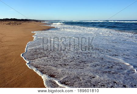 Wave and sand beach for background. Beautiful beach surface texture. Sea wave on sand beach digital illustration. Oceanic water tide on seashore.
