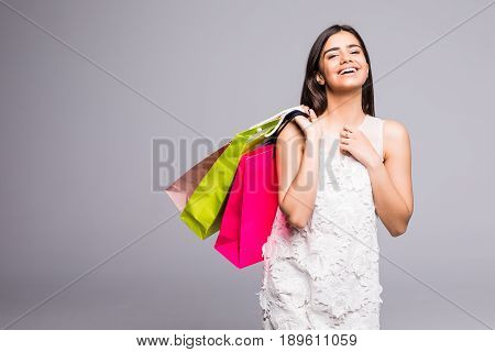 Young Happy Summer Shopping Woman With Shopping Bags On Grey Background