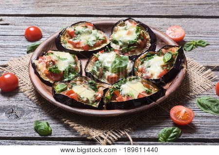 Mini pizza with eggplant tomato and basil