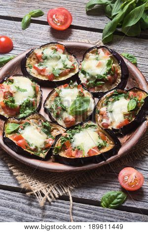 Mini pizza with eggplant tomato and basil