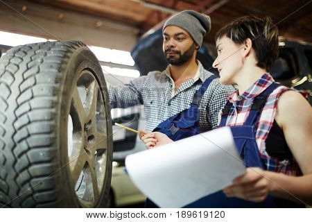 Head master explaining to protege tire characteristics