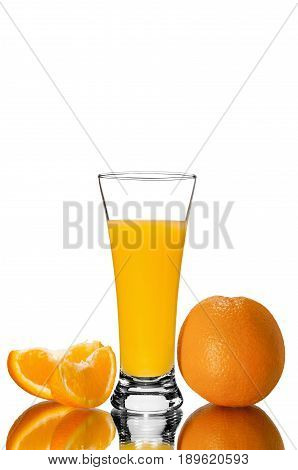 glass of orange juice and orange pieces mirror reflection isolated background