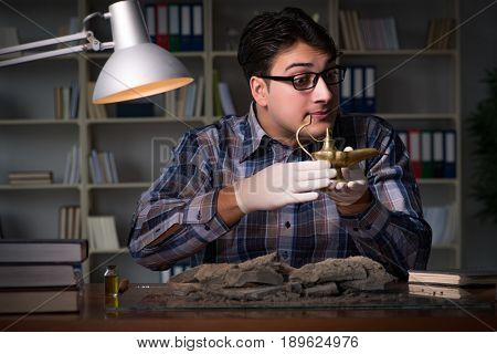 Archeologist working late night in office