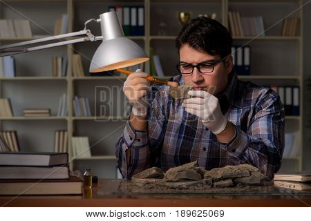 Archeologist working late night in office