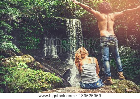 Male and woman couples asia. Walking hand travelers travel nature Forests mountains waterfalls. puhinrongkla romklao-paradorn waterfall