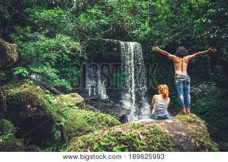 Male and woman couples asia. Walking hand travelers travel nature Forests mountains waterfalls. puhinrongkla romklao-paradorn waterfall