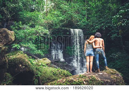 Male and woman couples asia. Walking hand travelers travel nature Forests mountains waterfalls. puhinrongkla romklao-paradorn waterfall