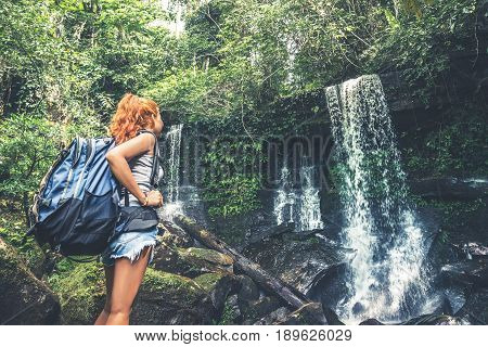 woman asia travelers travel. Walking hand travelers travel nature Forests mountains waterfalls. puhinrongkla romklao-paradorn waterfall