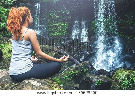 woman asia travelers travel. Walking hand travelers travel nature Forests waterfalls. puhinrongkla romklao-paradorn waterfall. Meditate on yoga