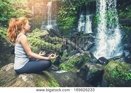 woman asia travelers travel. Walking hand travelers travel nature Forests waterfalls. puhinrongkla romklao-paradorn waterfall. Meditate on yoga