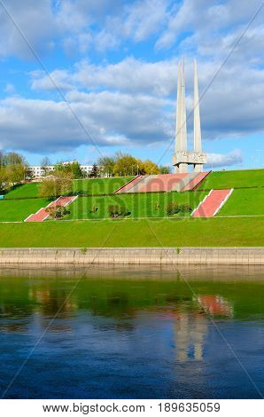 VITEBSK BELARUS - MAY 16 2017: Beautiful view of embankment of Zapadnaya Dvina river and memorial complex in honor of Soviet soldiers-liberators partisans and underground workers (