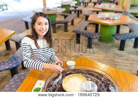 Woman eating somen in japanese restaurant
