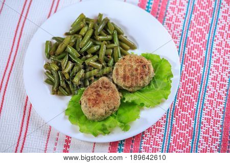 Cutlets With A Stuffing With A Garnish On A White Plate On A Light Background