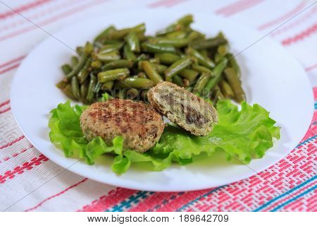 Cutlets With A Stuffing With A Garnish On A White Plate On A Light Background