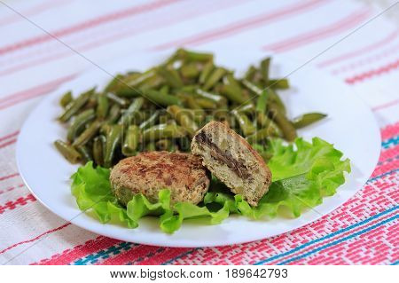 Cutlets With A Stuffing With A Garnish On A White Plate On A Light Background