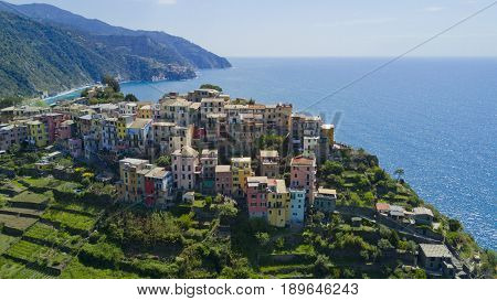 Aerial footage with drone on Corniglia, one of the famous Cinqueterre country, small village with colored houses on the cliff over the sea