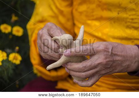 Tibetan monk sculpted figure of the deity of barley flour tsampa for Buddhist religious ceremony in Nepal. Close up